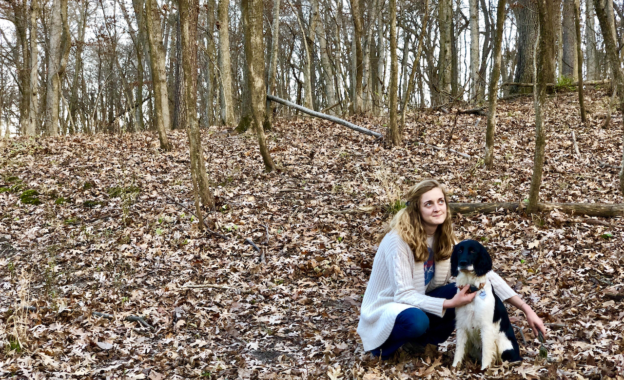 Danielle and her dog in the woods
